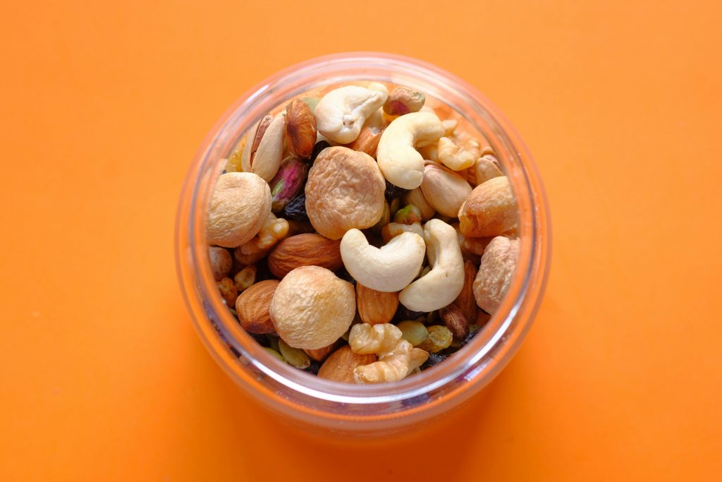 cashew nuts, almonds and walnuts in a jar.