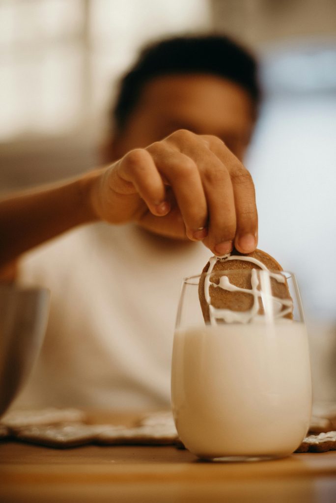 toddler with glass of milk