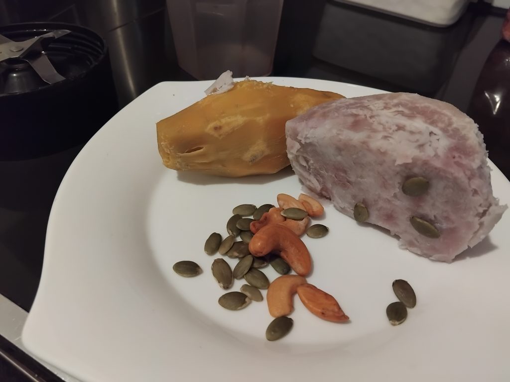 boiled sweet potatoes, boiled arrowroot, cashew nuts and pumpkin seeds on a plate